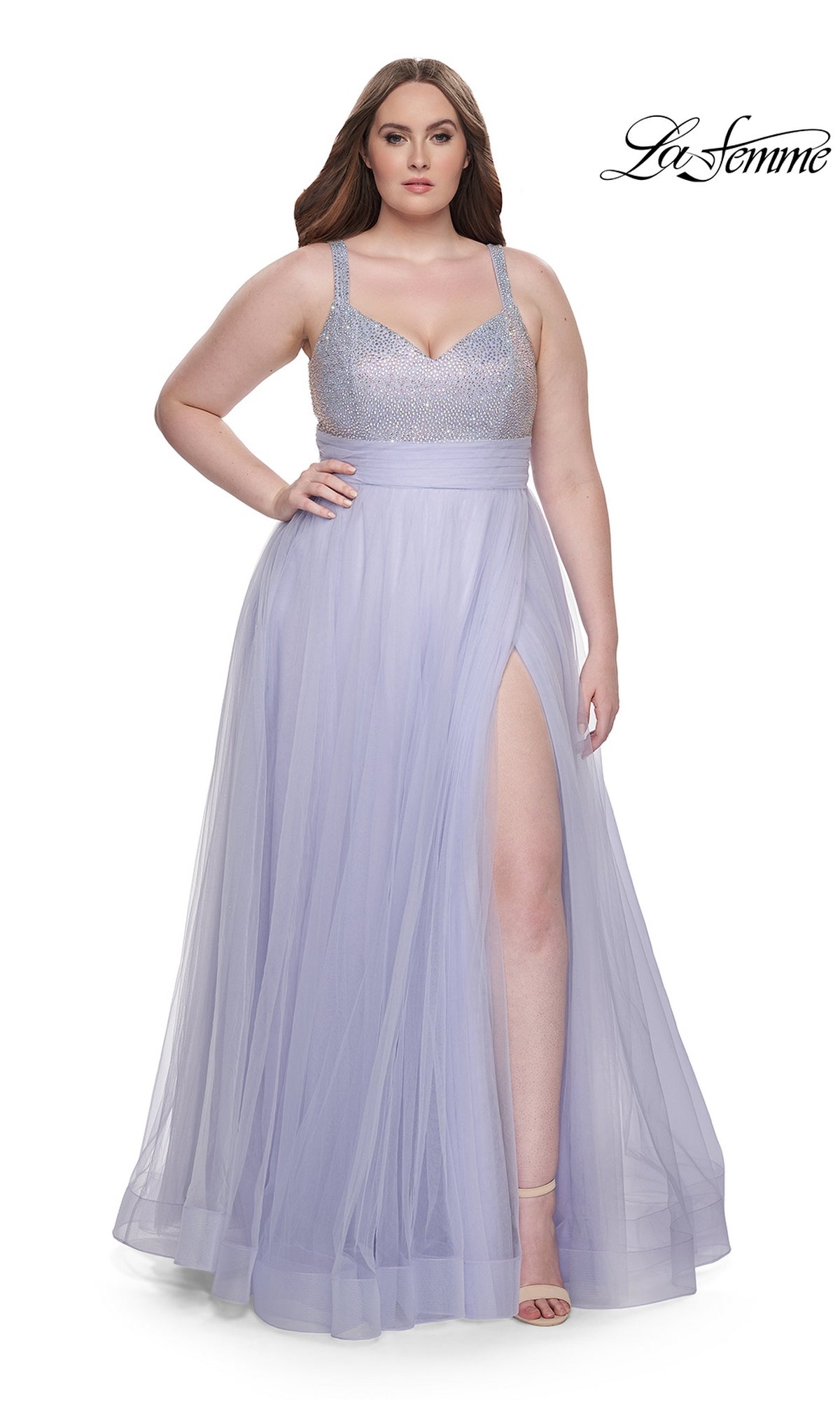 A woman poses with one hand on her hip in the La Femme Long Prom Dress 31251, a sleeveless light periwinkle gown featuring a beaded bodice and a high slit in the tulle skirt.